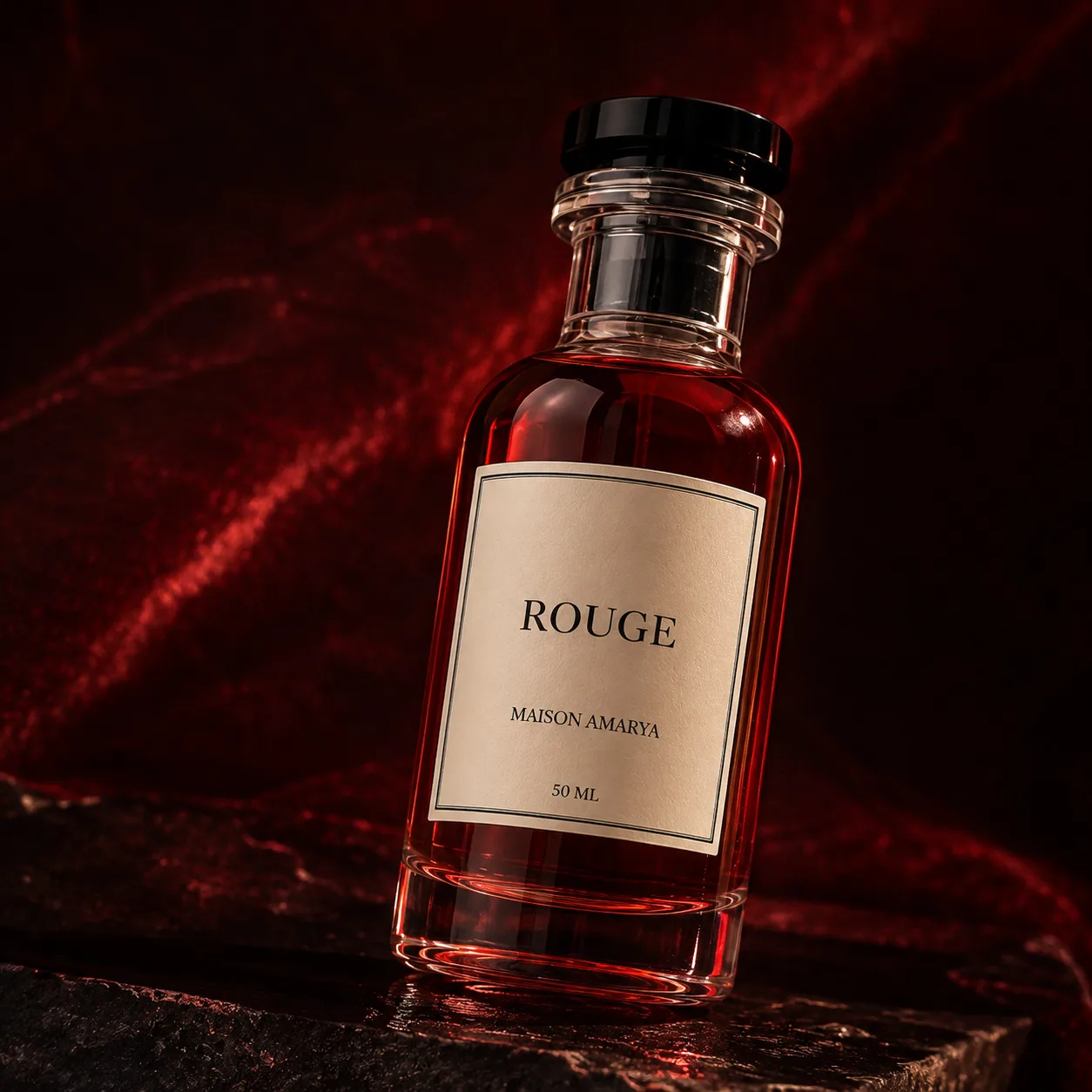 Gros plan du flacon d’extrait de parfum Rouge et de son étiquette, sur un marbre veiné.